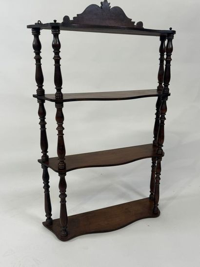 Small four-tier wall shelf in turned wood.
78...