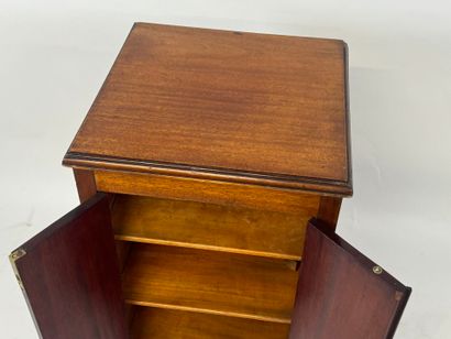 Mahogany cabinet opening with two doors,...