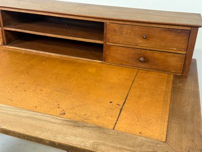 Tiered desk in molded wood opening with three...