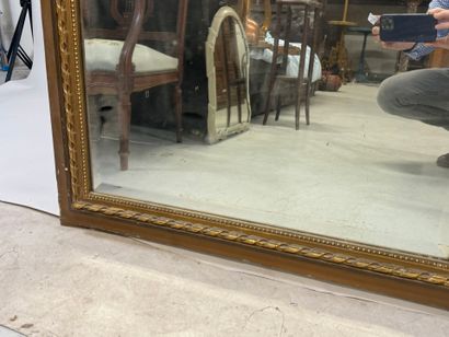 Large mirror in wood and gilded stucco, the...