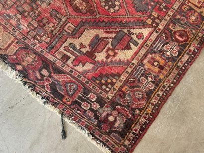 Hand-knotted wool rug with geometric motifs.
200...