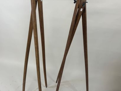 Two wooden tripods, one with a telescope...