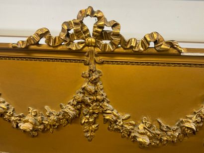 Large mirror in wood and gilded stucco, the...