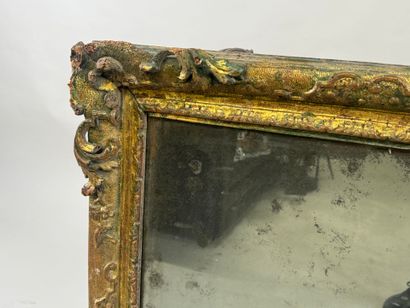 Carved wood mirror with foliate scrolls.
93...