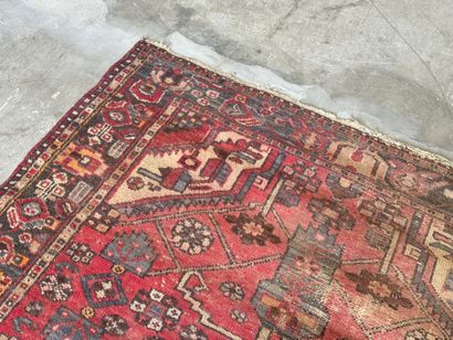 Hand-knotted wool rug with geometric motifs.
200...