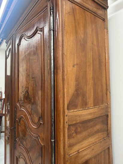 Large walnut armoire opening with two molded...