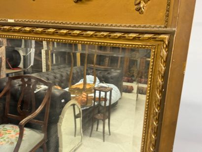 Large mirror in wood and gilded stucco, the...