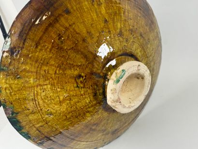 Large circular dish on heel in glazed ceramic...