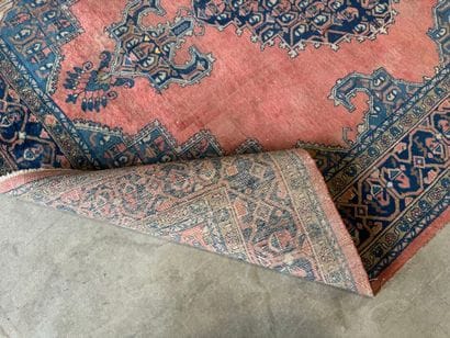 Large hand-knotted wool rug with stylized...