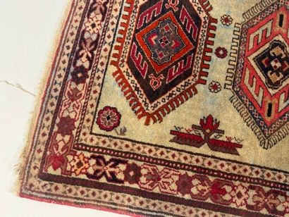 Small hand-knotted wool rug with stylized...