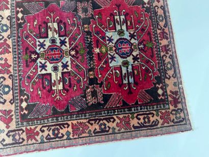 Small hand-knotted wool rug with stylized...