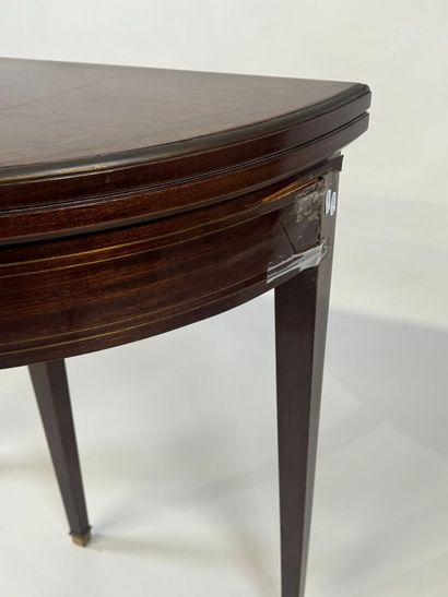 Mahogany veneered half-moon game table.
Louis...