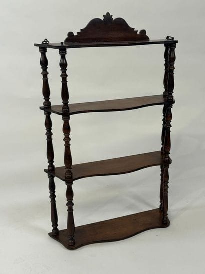 Small four-tier wall shelf in turned wood.
78...