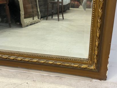 Large mirror in wood and gilded stucco, the...