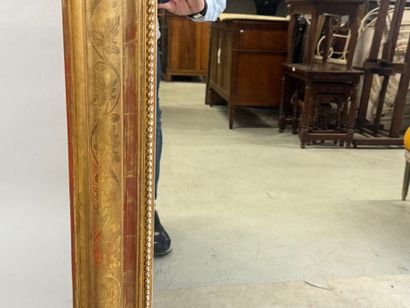 Wood and gilded stucco mirror decorated with...