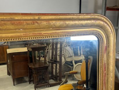Wood and gilded stucco mirror decorated with...