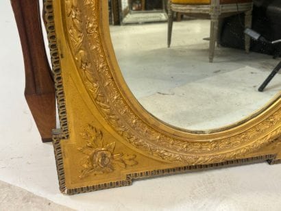 Wood and gilded stucco mirror with oval view,...
