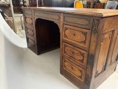 Large molded and carved oak desk decorated...
