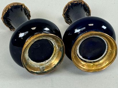 A pair of blue earthenware vases, with chased...