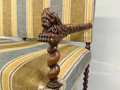 Molded and twisted wood bench, the arms decorated...