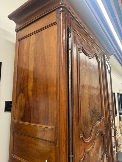 Large walnut armoire opening with two molded...
