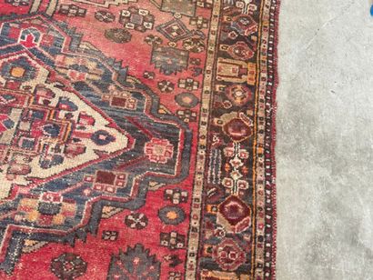 Hand-knotted wool rug with geometric motifs.
200...