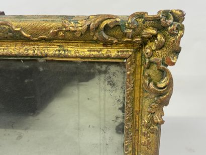 Carved wood mirror with foliate scrolls.
93...