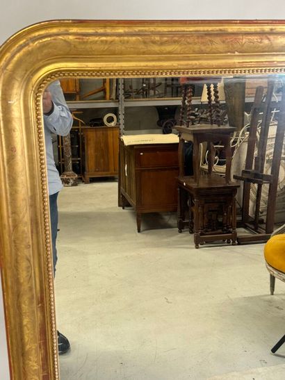 Wood and gilded stucco mirror decorated with...
