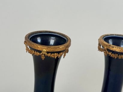 A pair of blue earthenware vases, with chased...