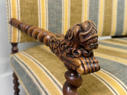 Molded and twisted wood bench, the arms decorated...