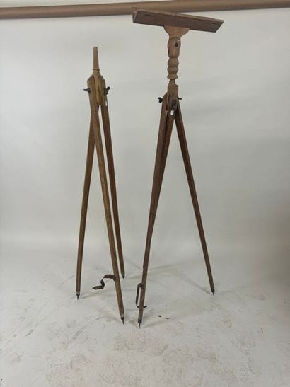 Two wooden tripods, one with a telescope...