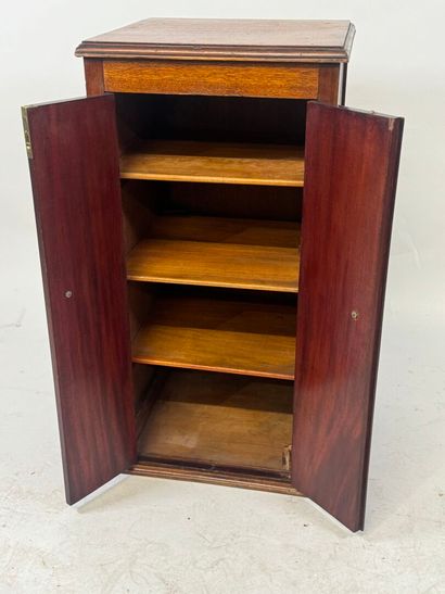 Mahogany cabinet opening with two doors,...