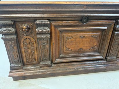 Large molded and carved oak desk decorated...