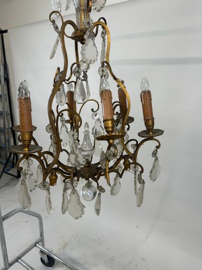 Six-arm bronze chandelier with crystal pendants.
H....