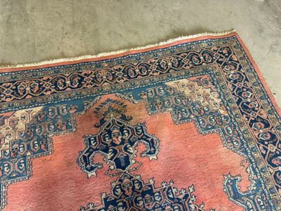 Large hand-knotted wool rug with stylized...
