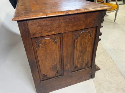 Large molded and carved oak desk decorated...