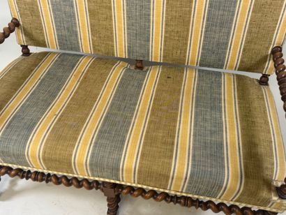 Molded and twisted wood bench, the arms decorated...