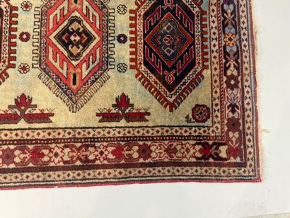 Small hand-knotted wool rug with stylized...