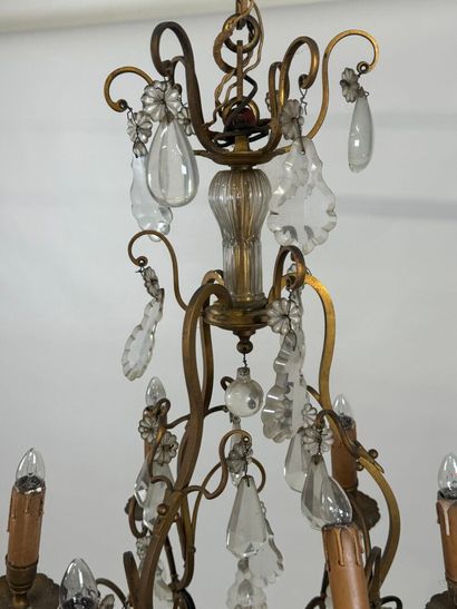 Six-arm bronze chandelier with crystal pendants.
H....