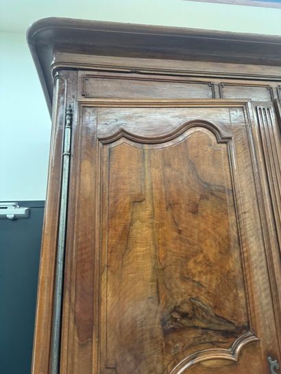 Large walnut armoire opening with two molded...