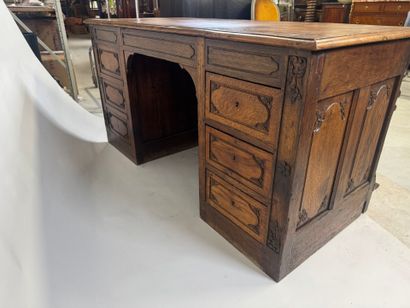 Large molded and carved oak desk decorated...