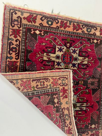Small hand-knotted wool rug with stylized...
