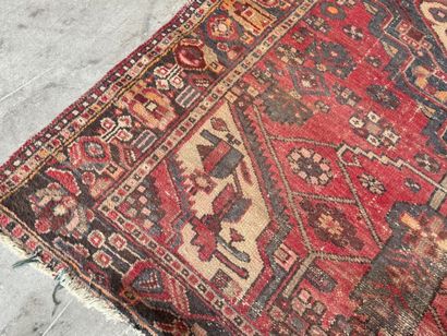 Hand-knotted wool rug with geometric motifs.
200...