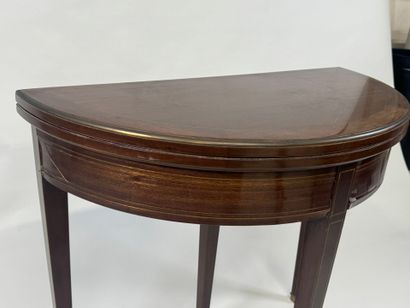 Mahogany veneered half-moon game table.
Louis...