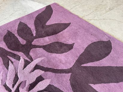 Large woollen rug on a violet ground, decorated...
