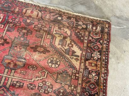 Hand-knotted wool rug with geometric motifs.
200...