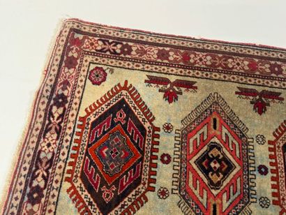 Small hand-knotted wool rug with stylized...