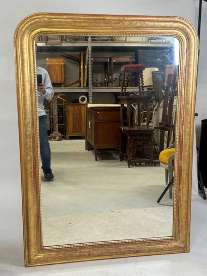 Wood and gilded stucco mirror decorated with...