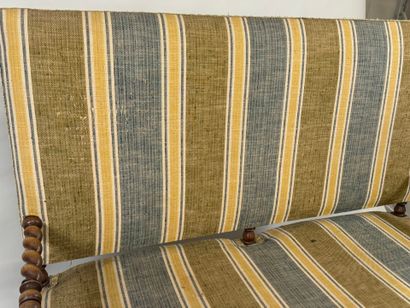 Molded and twisted wood bench, the arms decorated...