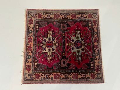 Small hand-knotted wool rug with stylized...